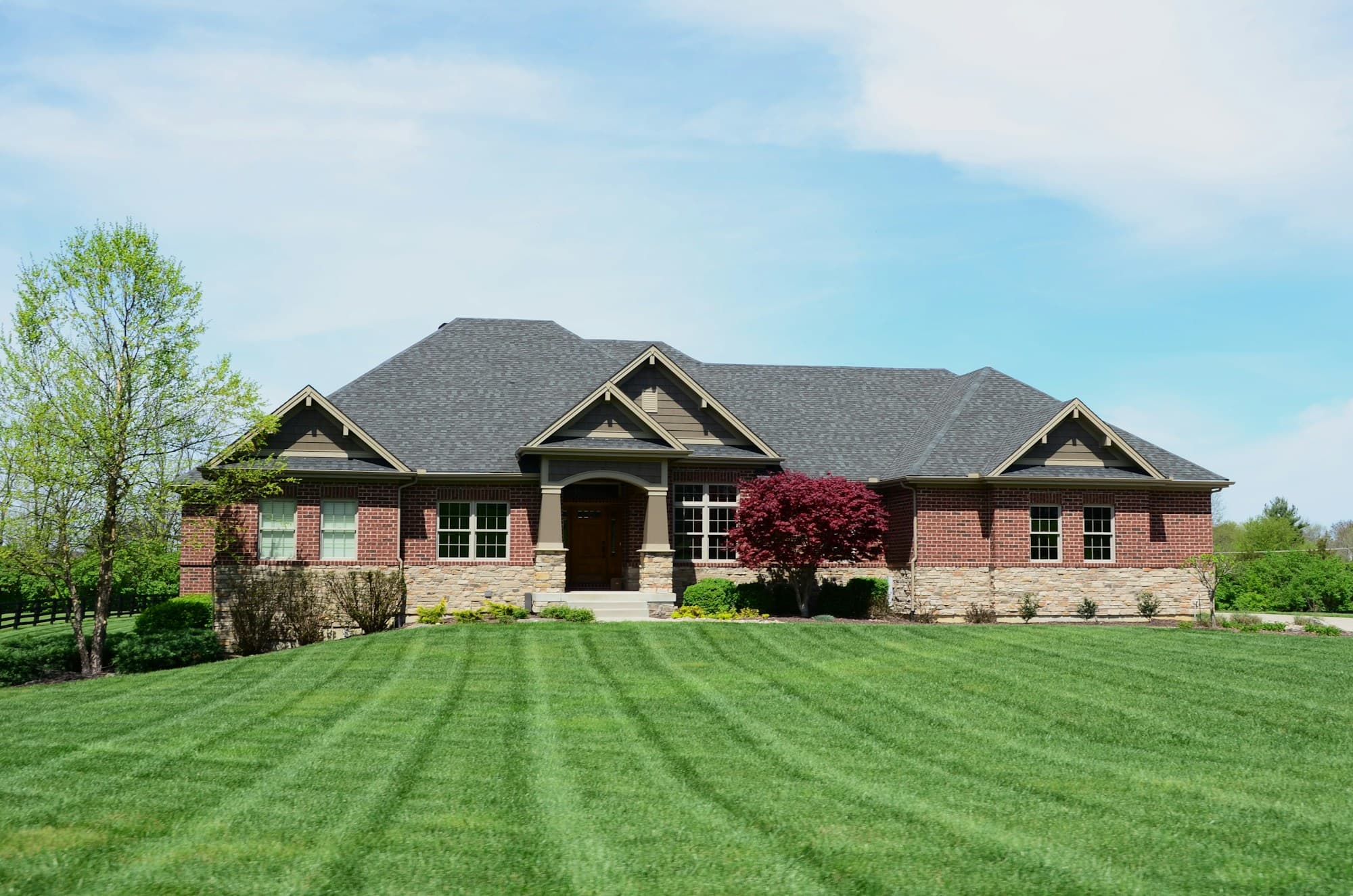 Lush professionally maintained lawn with clean mowing stripes